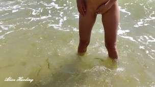 Alice washes in the sea after sex on a deserted beach with butt plug in the ass and without panties